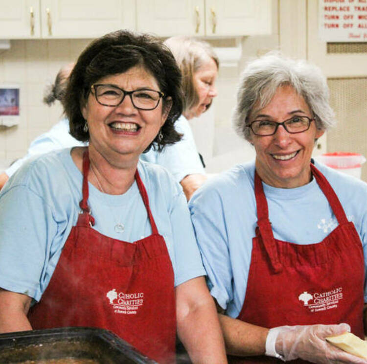 Two women in aprons smiling3